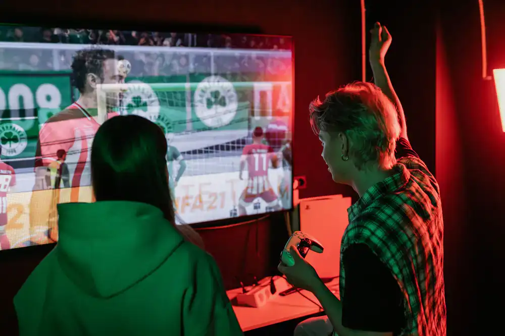 Football video game match on a large screen